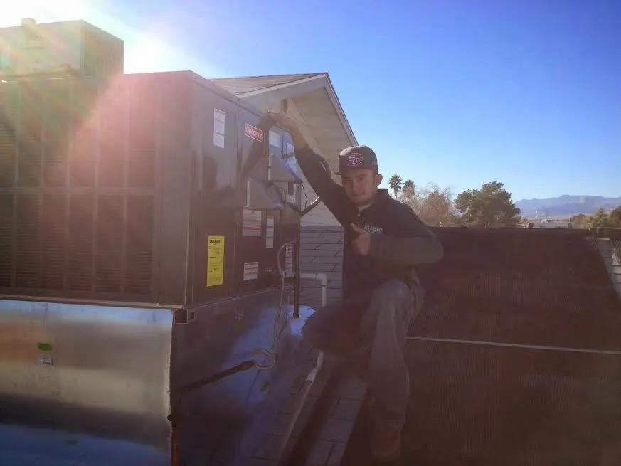 HVAC technician performing Heat Pump Repair on a rooftop unit in Cherokee Village